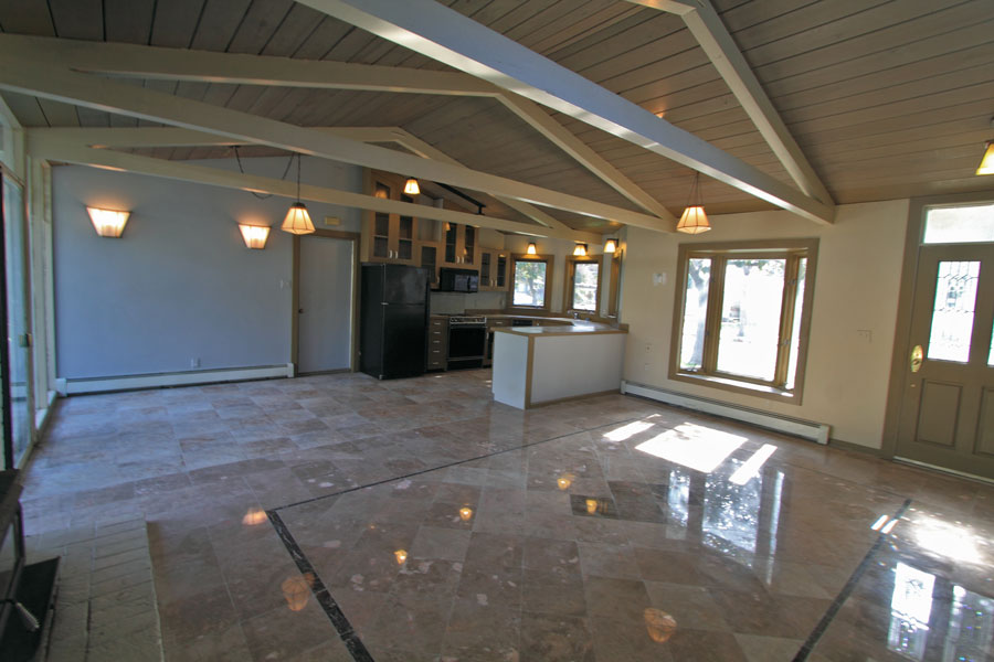 The kitchen is the corner of the open space.  Note the custom art deco lights and open beams.
