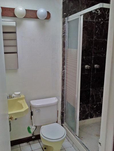 The bathroom has a marble shower and some pretty exciting fixture colors!
