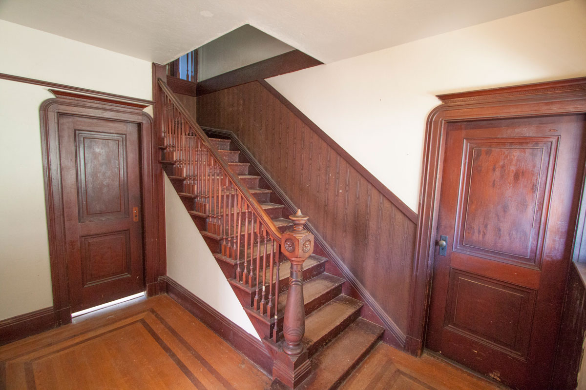 Notice the trim is original and has never been painted.  This is the front hall right inside the front door.  The Master BR is to the right and the living room to the left.  Three bedrooms are upstairs.