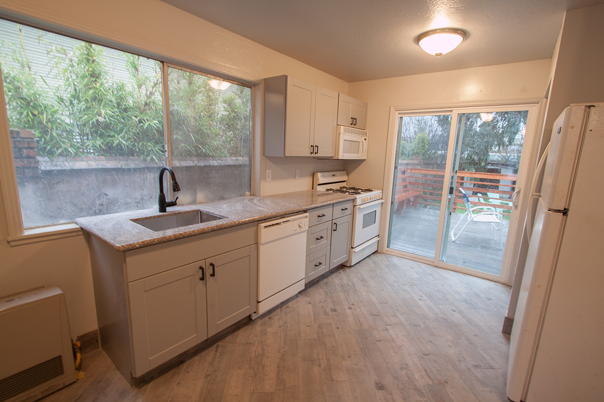 The kitchen is new, with a vented microwave hood, dishwasher and granite.