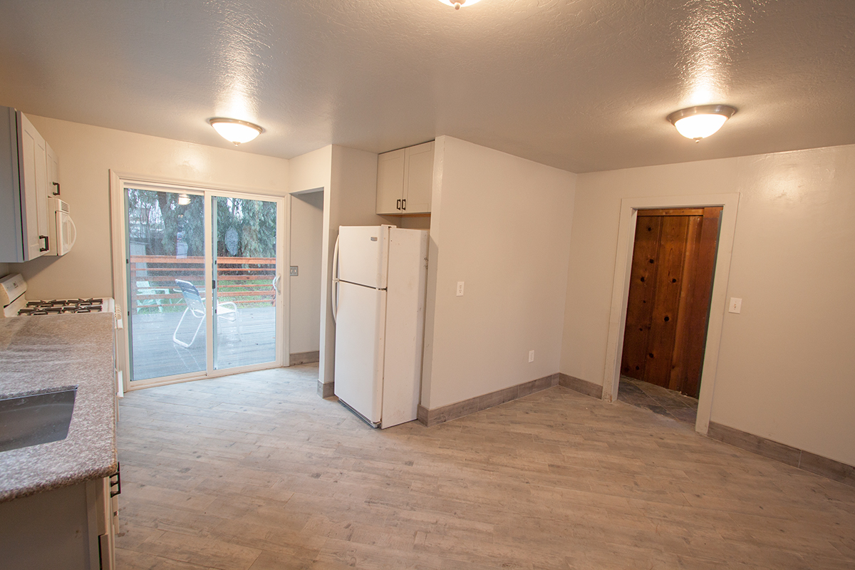 With the kitchen primarily to the left, the alcove in the center is for your stackable washer and dryer. The door to the right leads to the bedrooms.