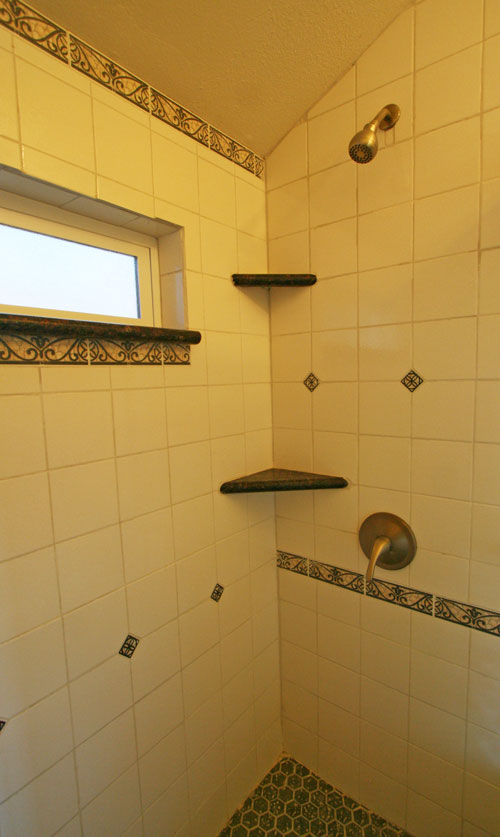 The main bathroom has a large tile shower.<