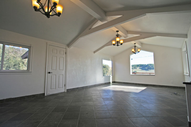 The living room is tile with an open ceiling and great views.  It is 14 x 24.