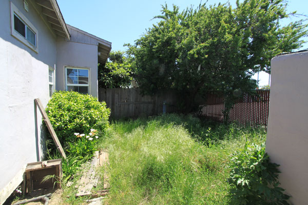 The fenced back yard has some shade, and includes a garage conversion which includes a kitchen and bath.  They are in pretty bad shape right now so this building would be best used for storage.