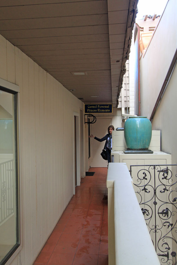 Follow the walkway between the buildings.  Go to the stairway on the left.